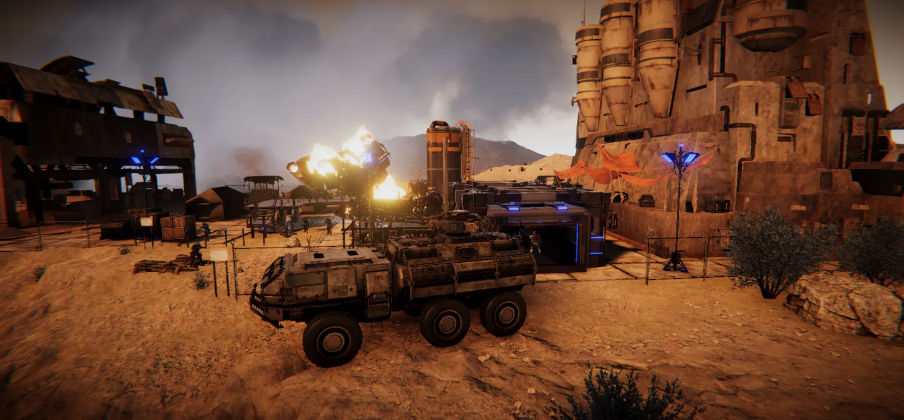 An armored vehicle and troops defend a battered desert military base.